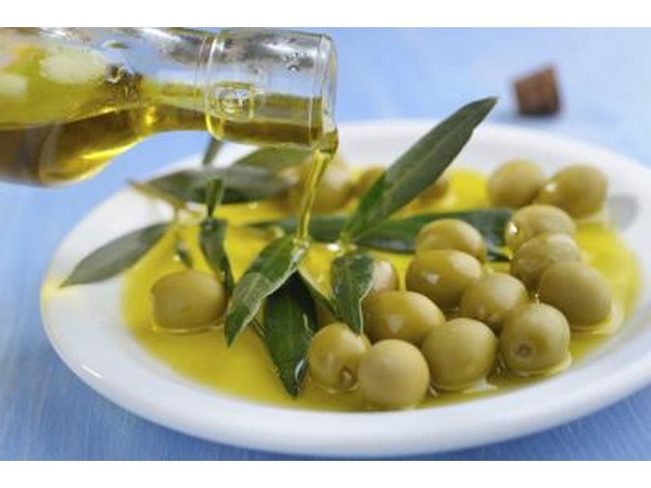 Fresh olive oil being poured into small dish.