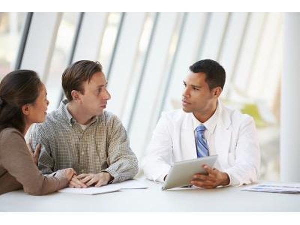 couple speaking with doctor