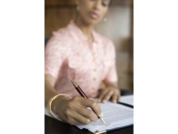 Woman signing paper