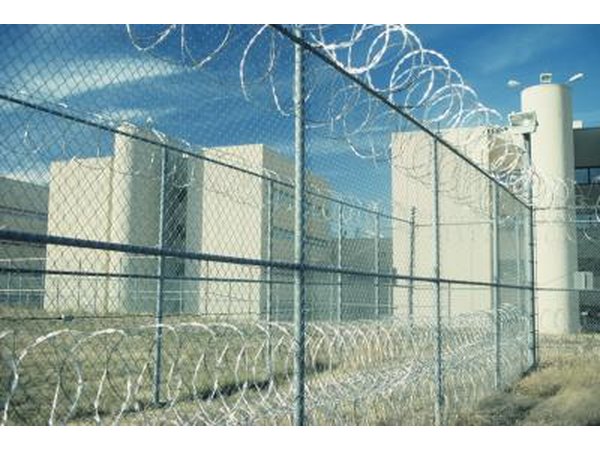 The view through a fence surrounding a prison.