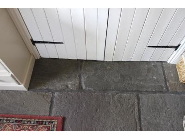Walls and doors that are painted different shades of white in a cottage sitting room.