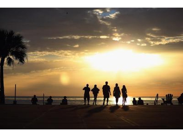 Couples watch the sun set from St. Pete Beach, FL.