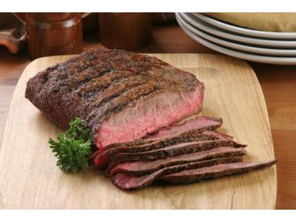 Sliced flank steak on cutting board.