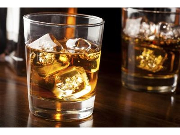 A glass with whiskey on the rocks.