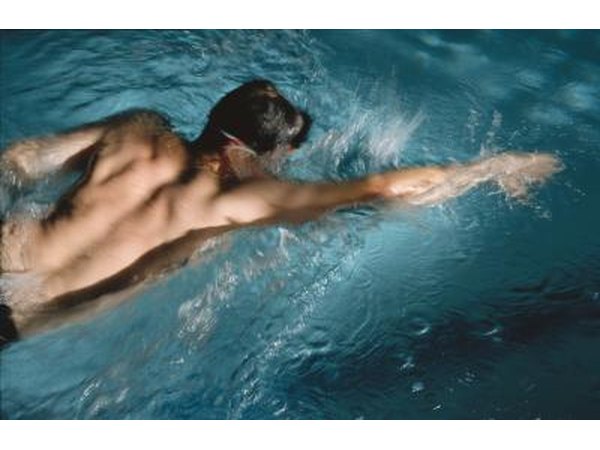 Man swimming in blue pool water