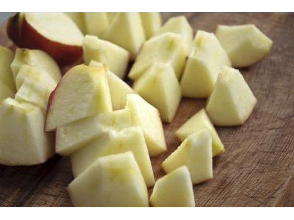Chopped apple pieces on a wood table