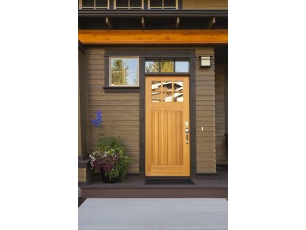 A rustic wood front door on a modern home.