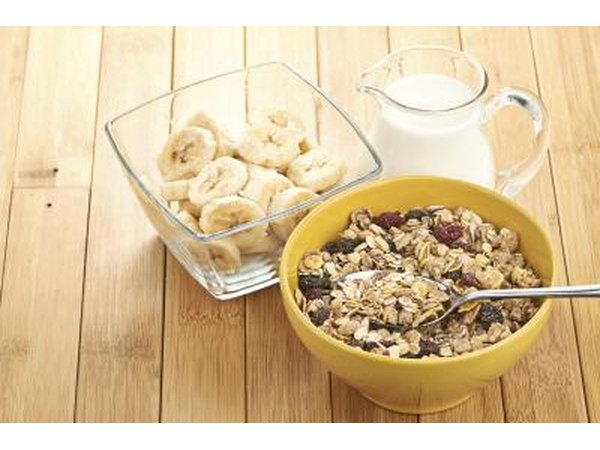 Bowl of cereal paired with small bowl of sliced bananas.