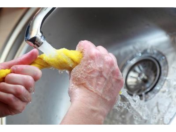Hands wringing out wet cloth
