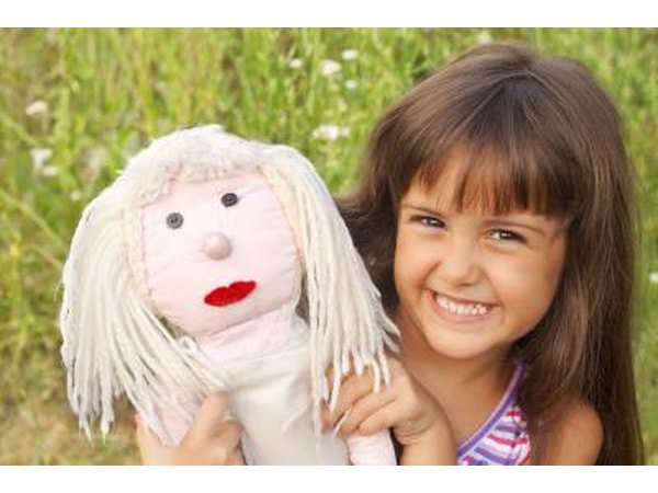 Girl holding doll