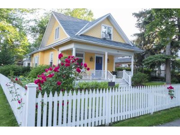 White picket fence with bungalow landscape
