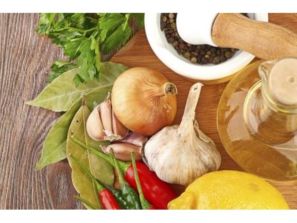 Fresh garlic, onions, bay leaves, cilantro, peppers, and oil