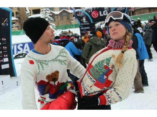 Snowboarders showing off sweaters at team event