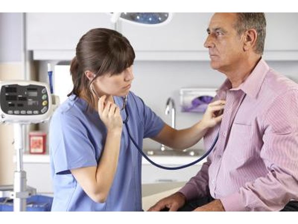 Nurse listening to man's heart and lungs