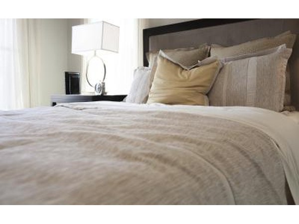 A traditional style bedroom with neutral earthy hues and textures.