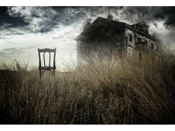 Chair in field next to old house