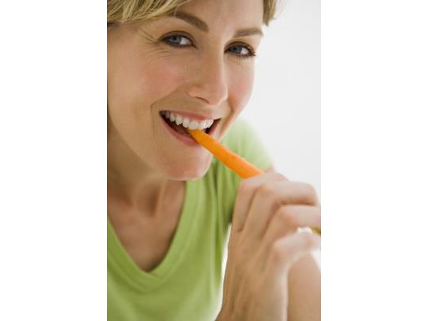 Woman eating a carrot