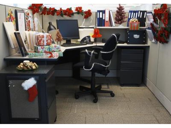 Cubicle decorated with wreaths, stockings and poinsettias for Christmas.