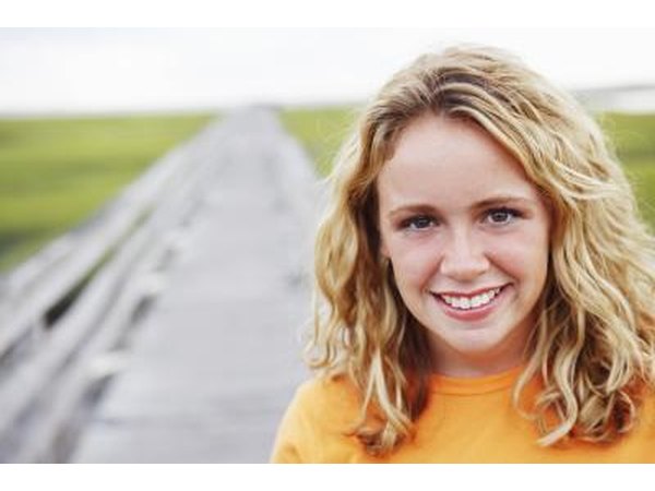 smiling woman in green barely field