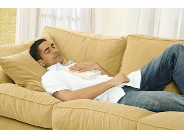 man sleeping on couch