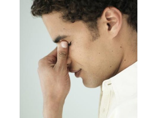 Man holding nose