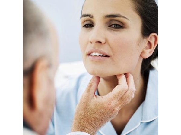 A doctor checks a womans throat for obstructions..