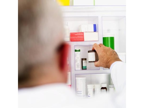 Man reaching for medication in cabinet
