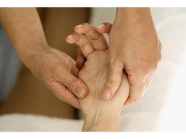 A woman gets her hand massaged