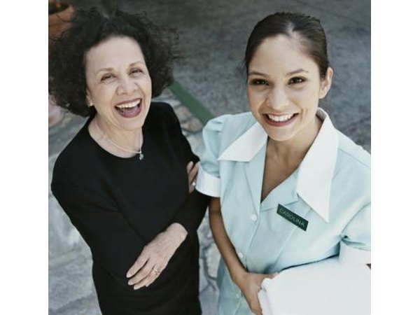 Hotel manager and maid smiling