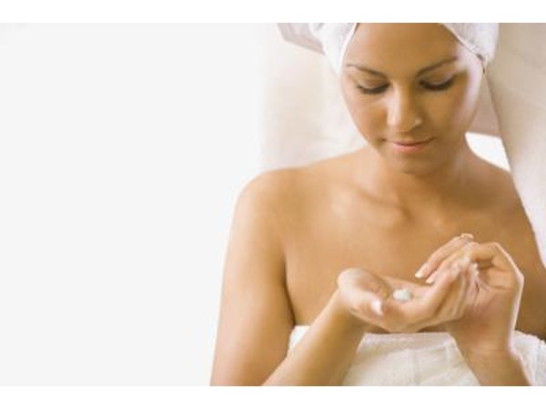 woman putting cream on face