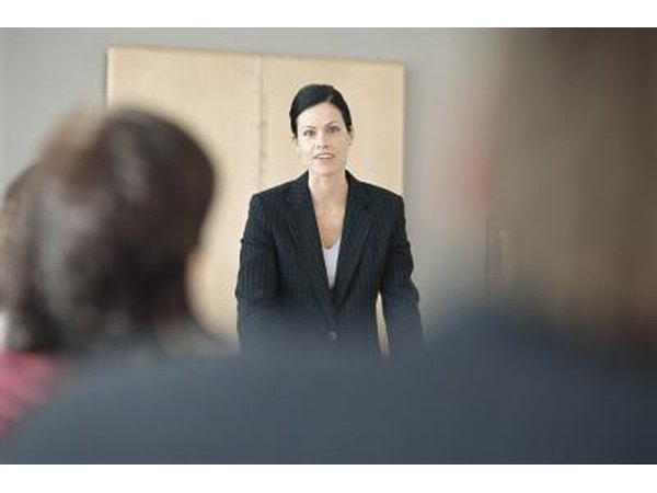 Woman speaking in front of a group.