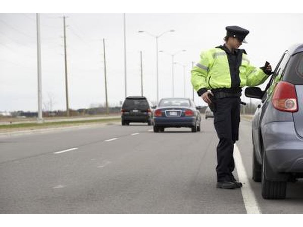 A female officer talks with a driver.