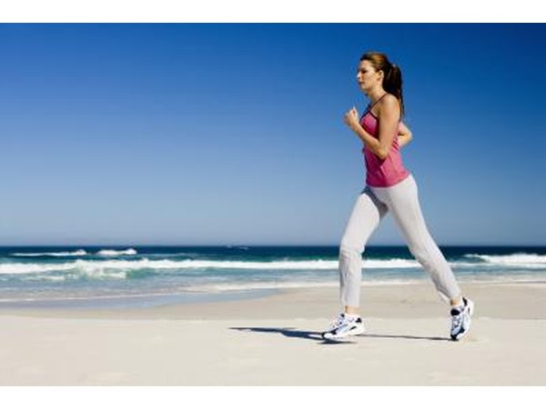A woman runs on a beach.