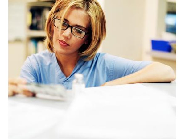Pharmacist reading prescription