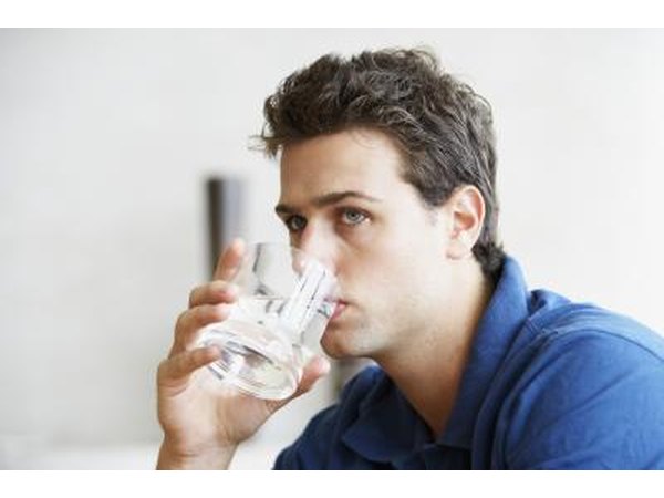 Young man drinking glass of water