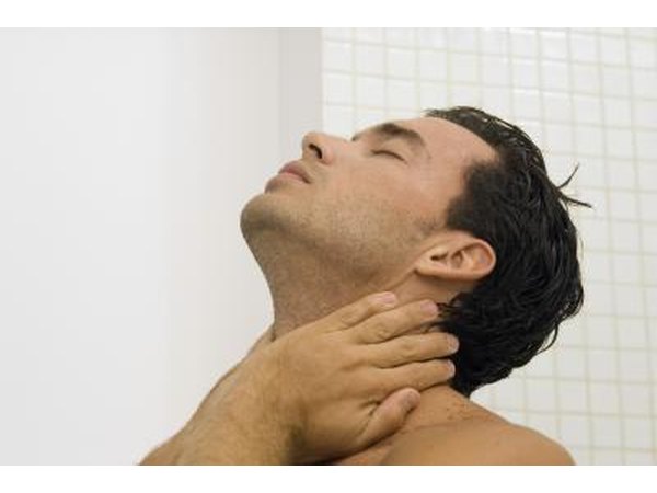 A man expieriences pain in the base of his neck.