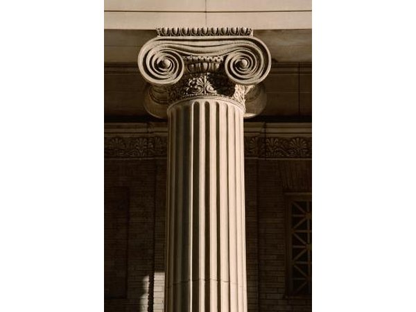 The scrollwork at the top of the column is indicative of the Ionic order.