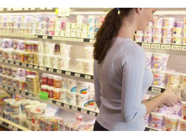 Woman in dairy aisle at supermarket