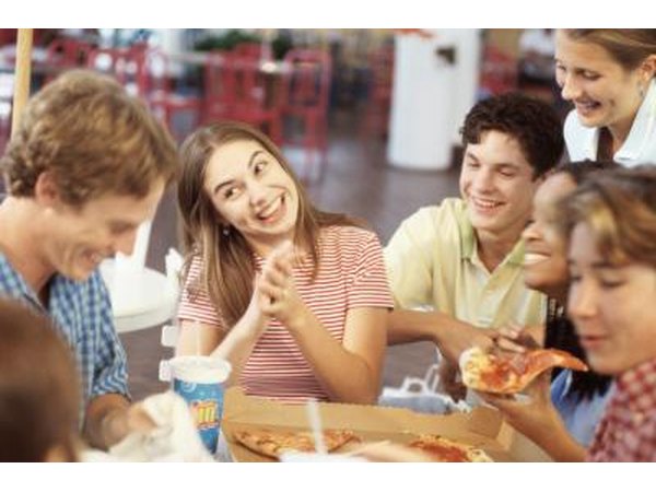 Teens eating pizza