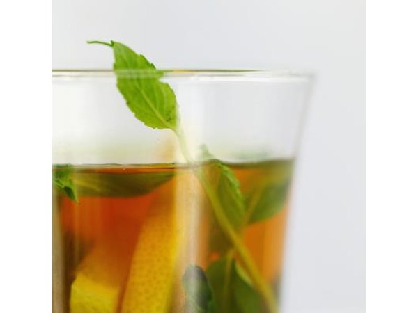 A cup of herbal tea with honey.