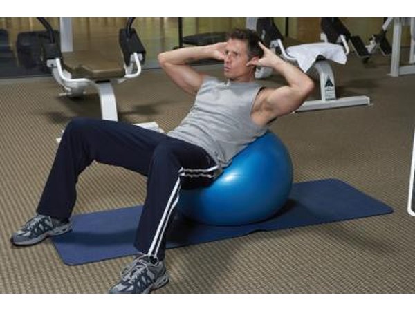 Man using a stability ball to do crunches.