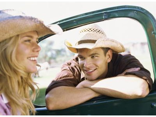 Young woman wearing cowboy hat in truck