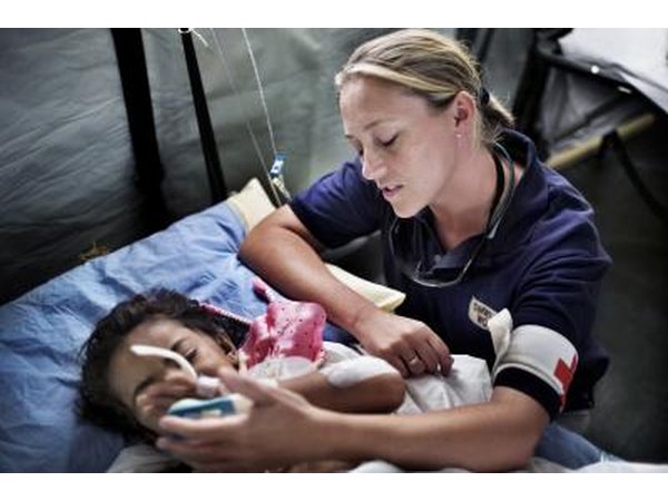 A Red Cross medic tends to a child.