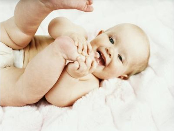 A baby naturally does Joyful Baby pose.