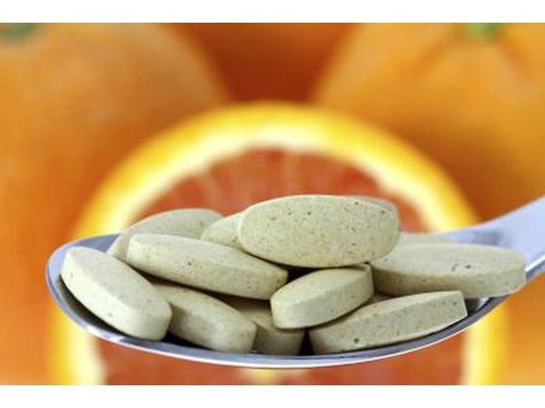 Vitamin C tablets on spoon