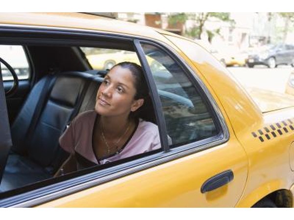 Young woman in backseat of cab.