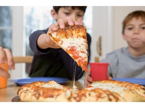Boys eating pizza