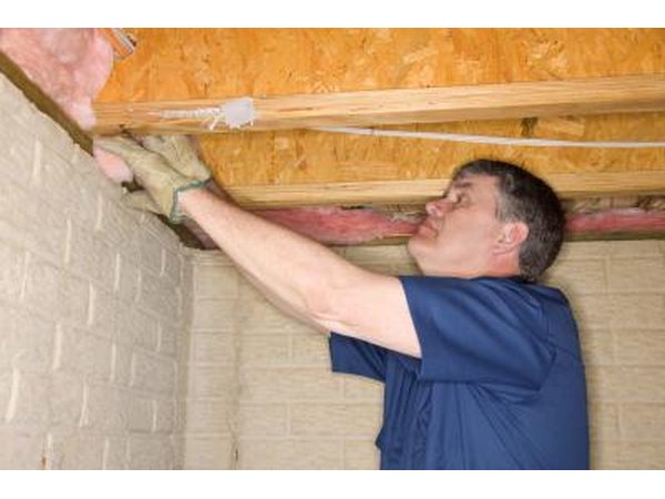 Man installing insulation