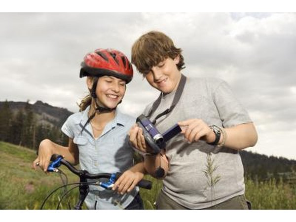 Teenagers looking at video camera