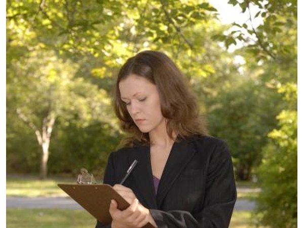 Woman with clipboard outdoors